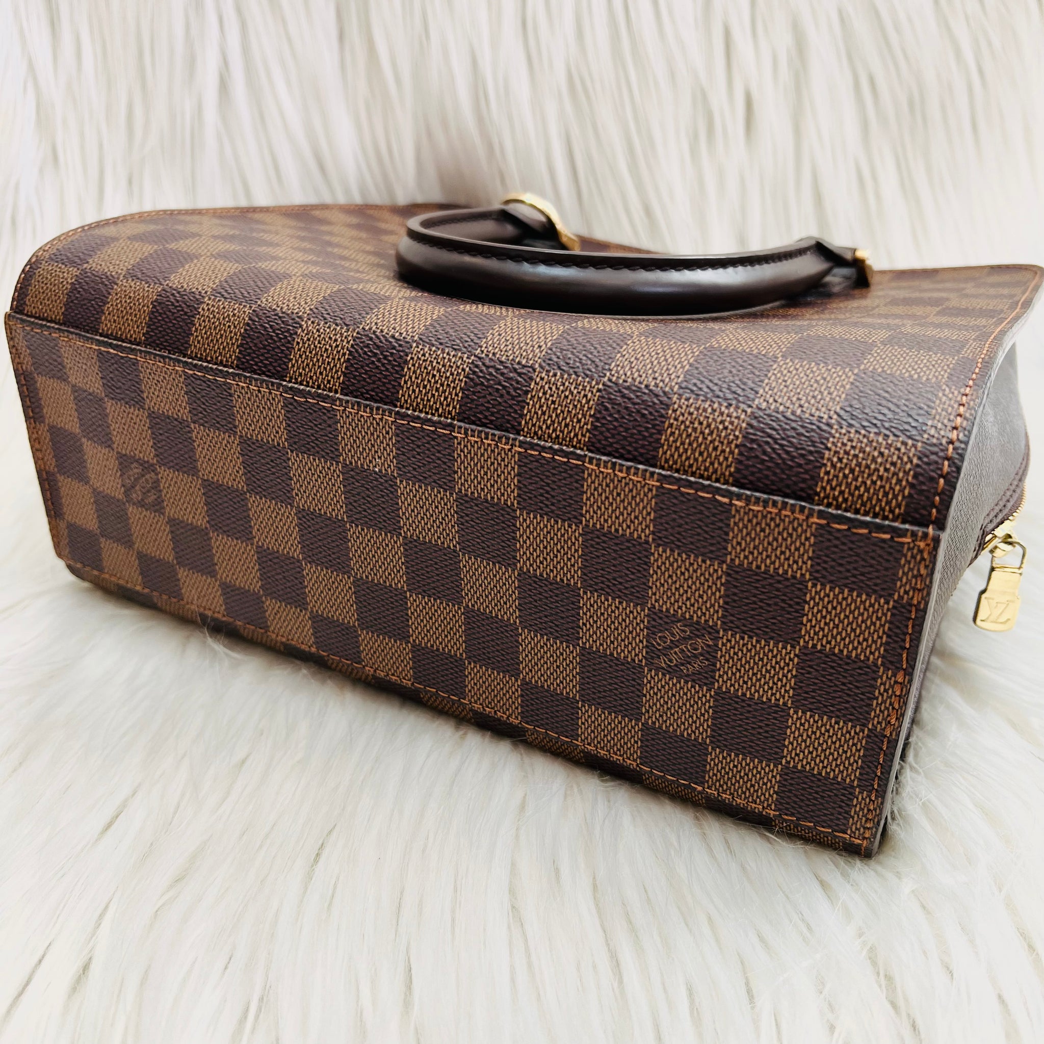 LV Damier Ebène Triana • Three compartments • Center double zipper closure  • Two open gusseted side sections • Internal zip pocket • Made…